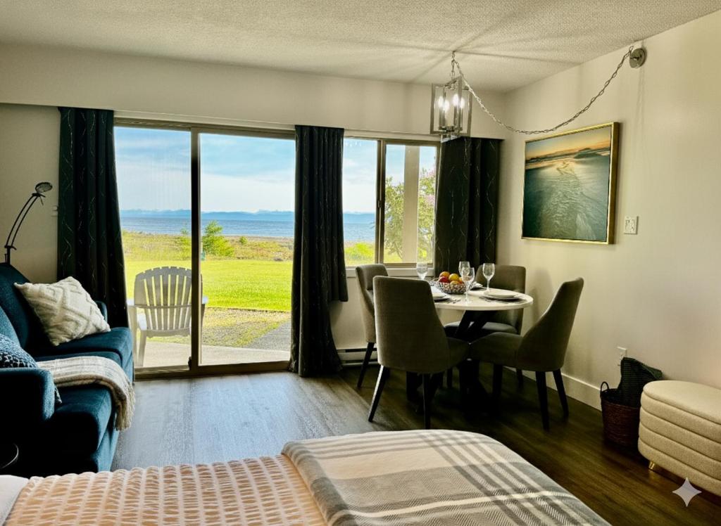 a living room with a table and a dining room at Shorewater Resort Oceanside Studio - 2 beds in Qualicum Beach