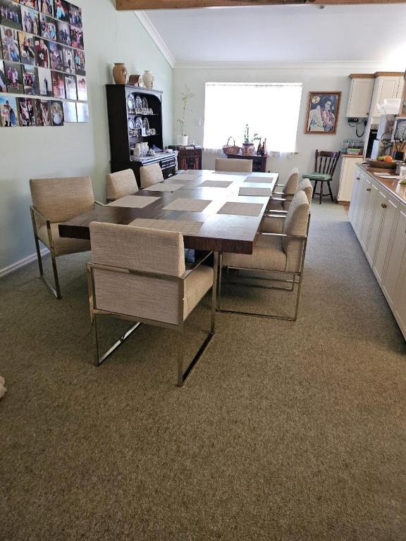 a living room with a dining room table and chairs at Murray's Bed & Breakfast in Gnowangerup