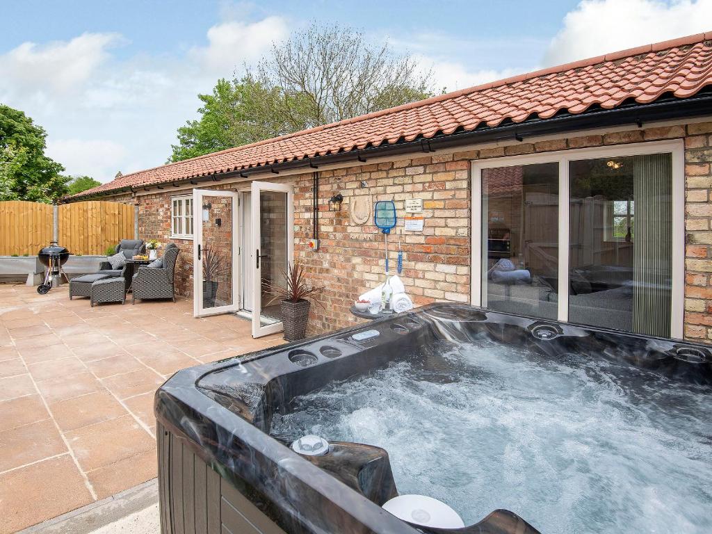a hot tub in the backyard of a house at The Shambles in Fulletby