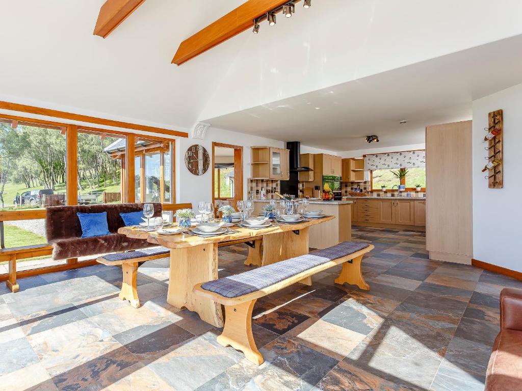a kitchen and living room with a wooden table at Sunnyside House in Duthil