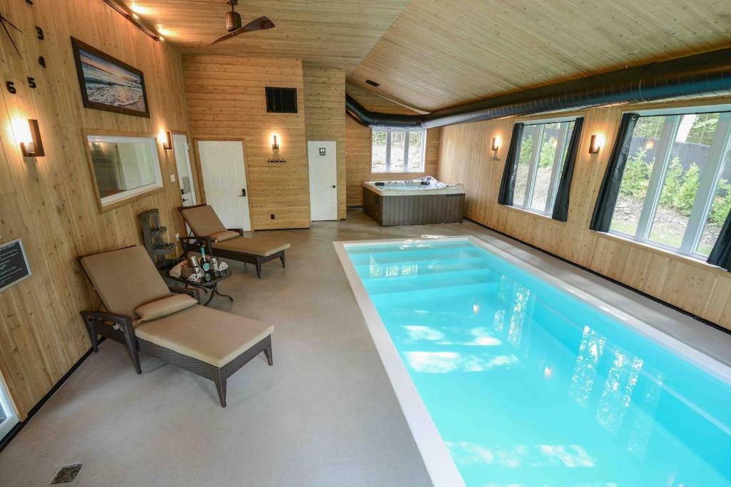 a large swimming pool in a house at Le SUMMUM in Sainte Anne des Lacs