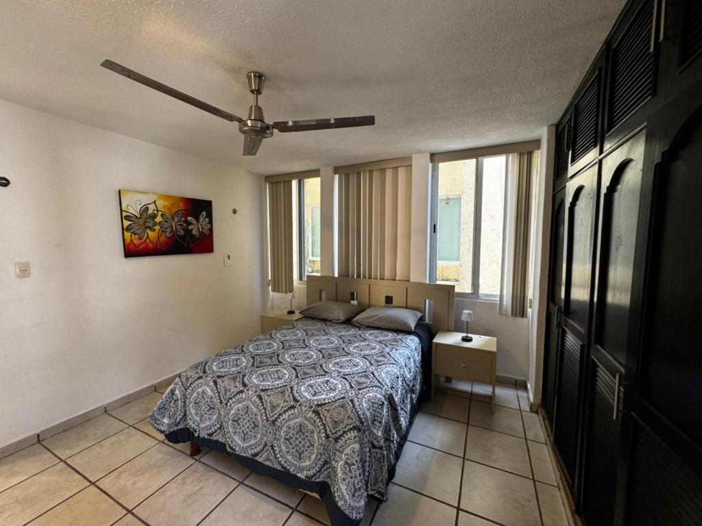 a bedroom with a bed and a ceiling fan at Las Fuentes in Mérida