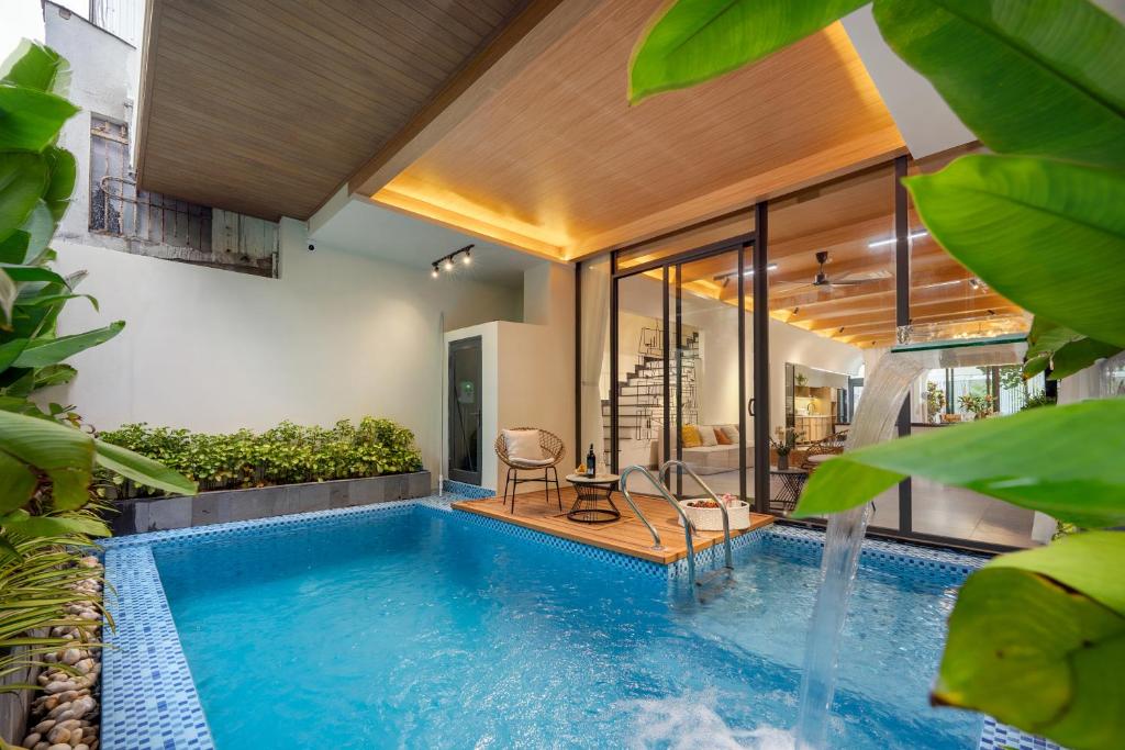 a swimming pool in the middle of a house at BQ Manor by Class6 in Danang