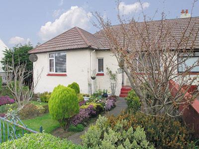 a white house with a garden in front of it at Anchorage in Maidens