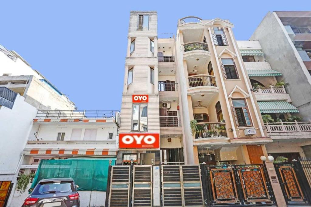 a apartment building with a sign in front of it at Hotel O Delhi Heights 2 Home stay in New Delhi