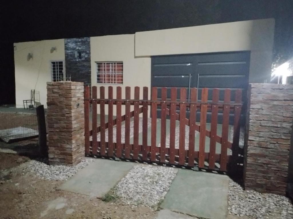 a gate in front of a house at night at Es aca in Jaureguiberry