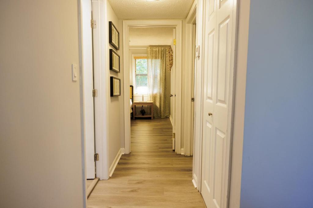 a long hallway with white walls and wooden floors at Stylish Stay in the Heart of Decatur King Bed in Decatur