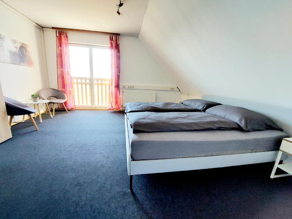 a bedroom with a bed and a large window at Guesthouse Graz Central for 9 People in Graz