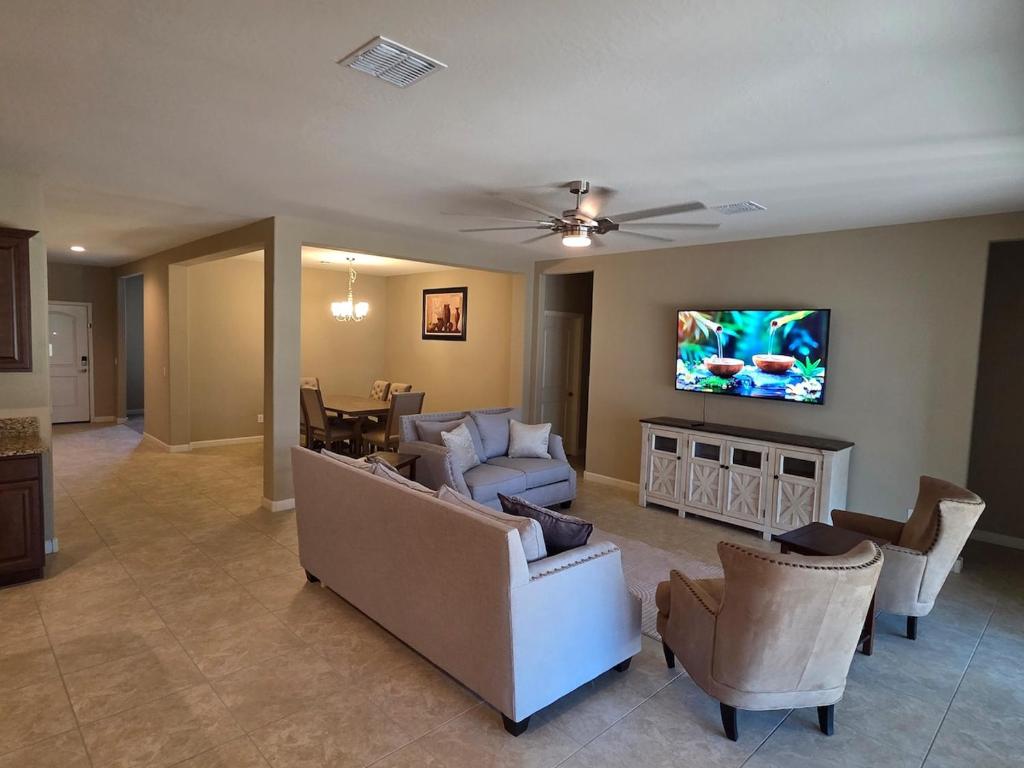 a living room with a couch and chairs and a tv at Comfortable Family Getaway in Buckeye in Buckeye