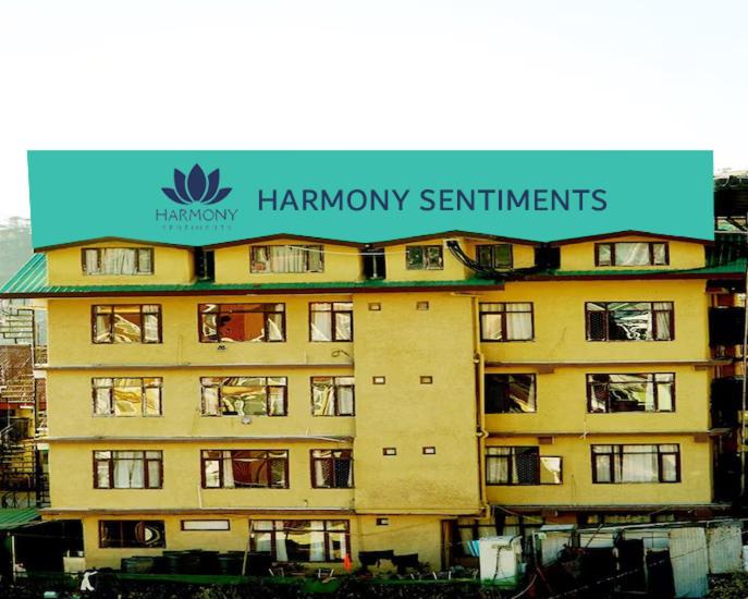 a large building with a sign on top of it at Harmony Sentiments in Jāmb