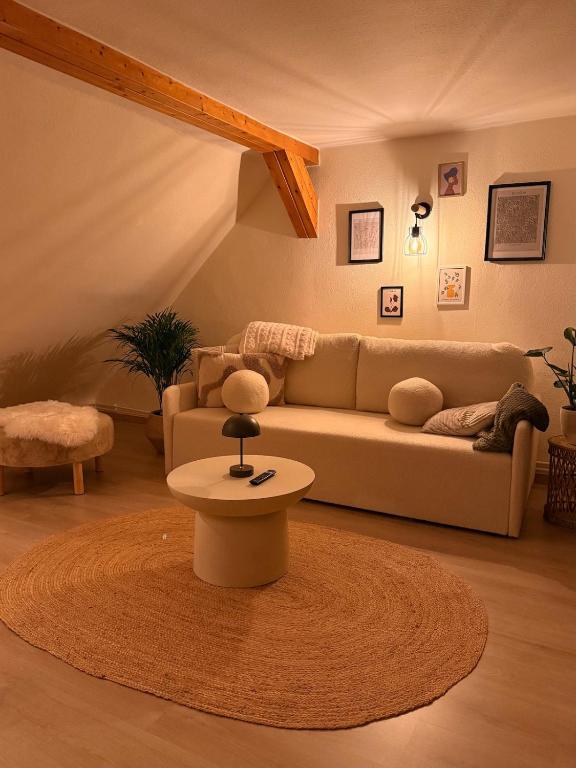a living room with a couch and a table at Wohlfühloase Goslar no 3 in Goslar