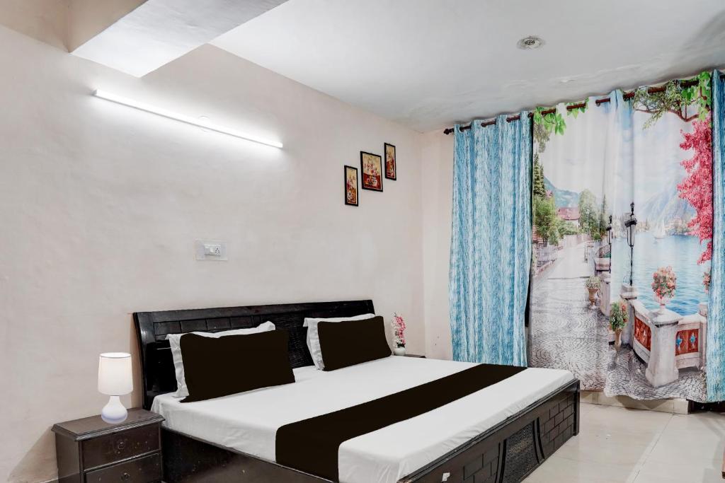 a bedroom with a large bed and a window at Hotel O Basera in Dalhousie