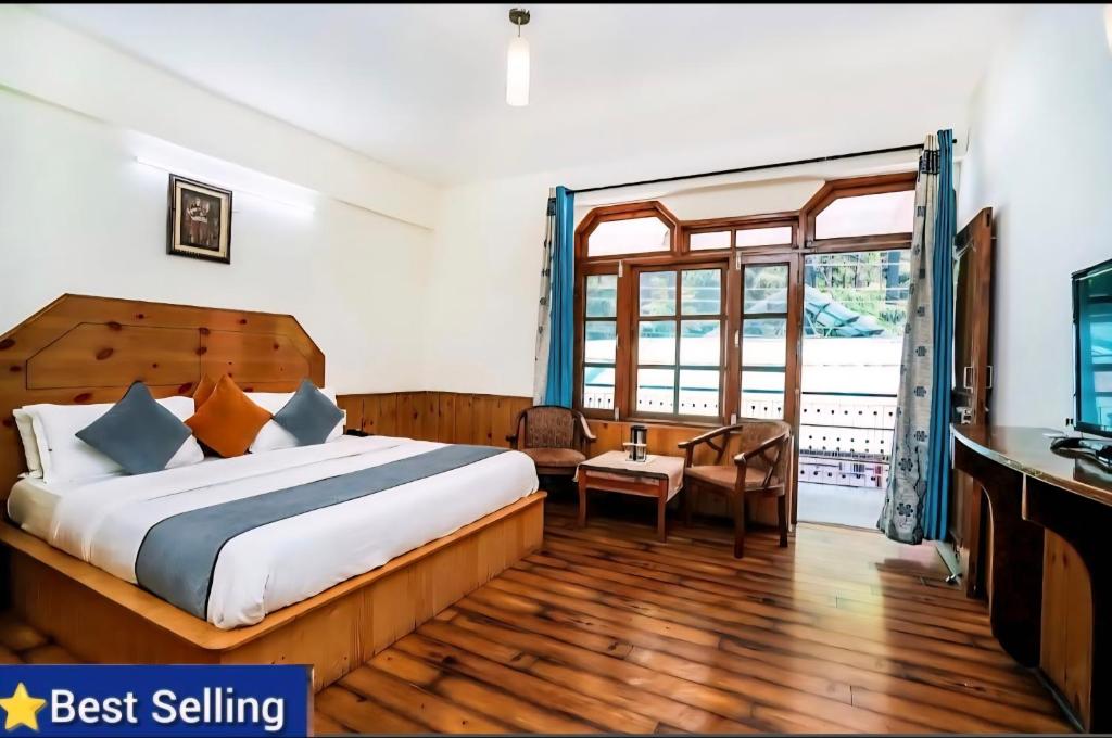 um quarto com uma cama, uma escrivaninha e uma janela em Ramta Jogi Hotel & Stays em Manali