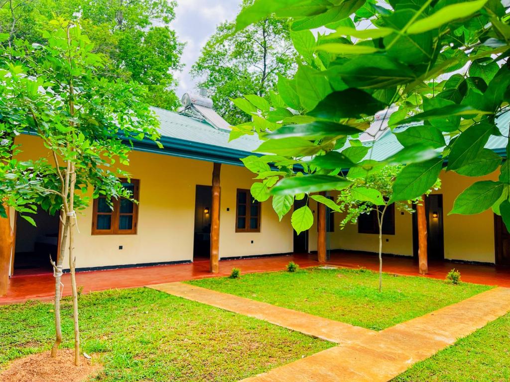 a house with a garden in front of it at Liyara Lodge Sigiriya in Sigiriya