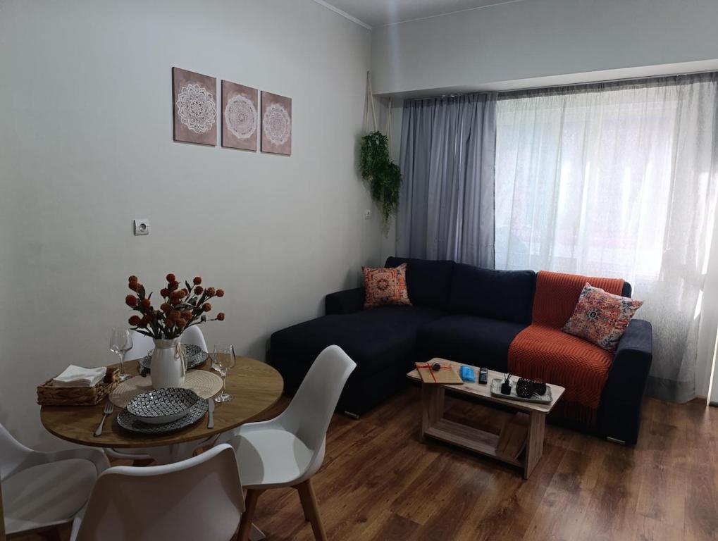 a living room with a couch and a table at Studio35 in Athens