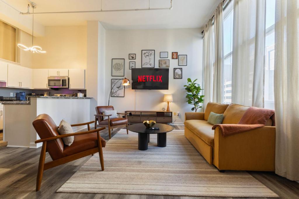 a living room with a couch and a table at Indy Urban Nest - Sleeps 8 - Skywalk Access - Convention Center - Stadium in Indianapolis