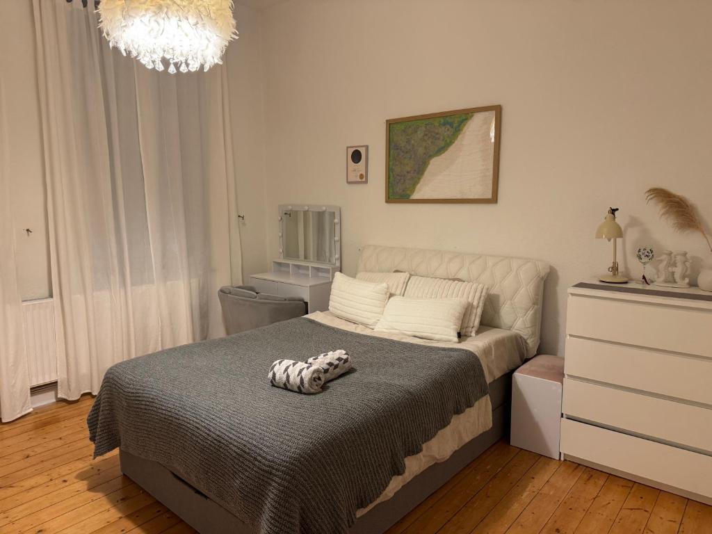 a bedroom with a bed and a dresser at Agt Hannover Messe Zimmer in Hannover