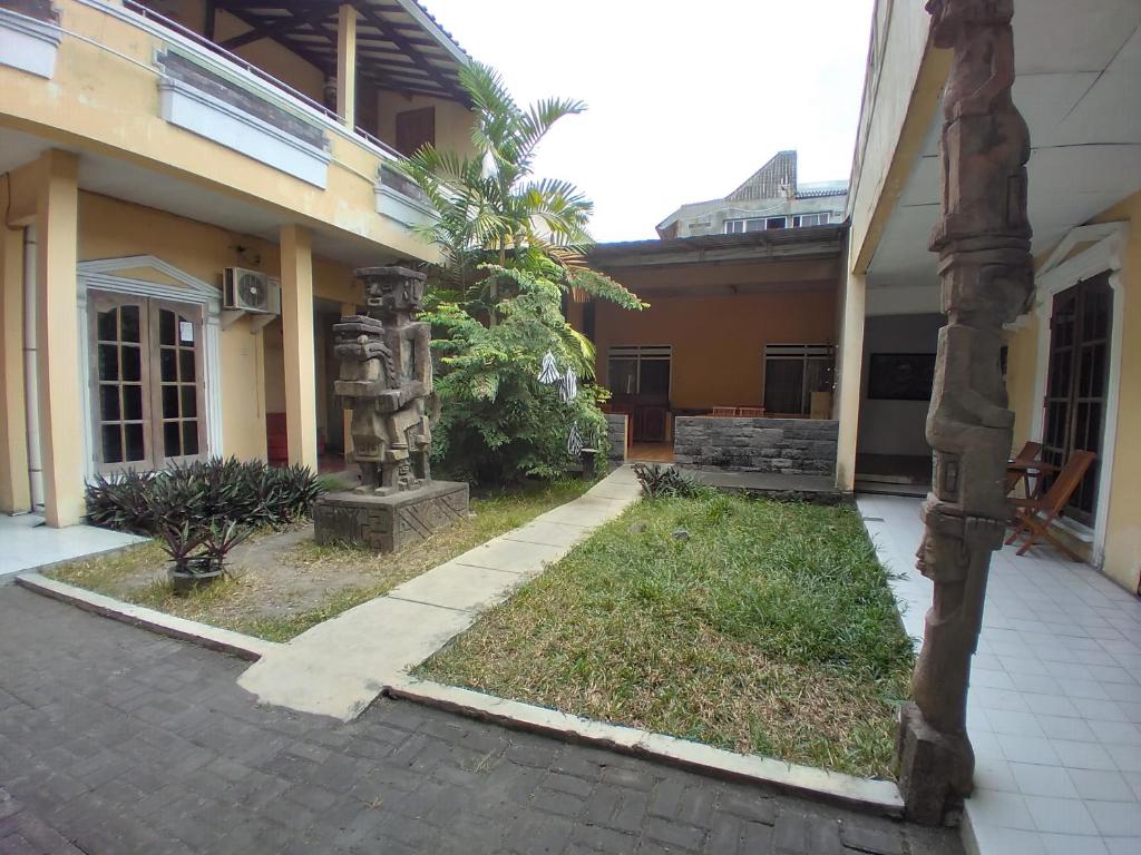 an outside view of a house with a courtyard at Duta Kencana in Timuran