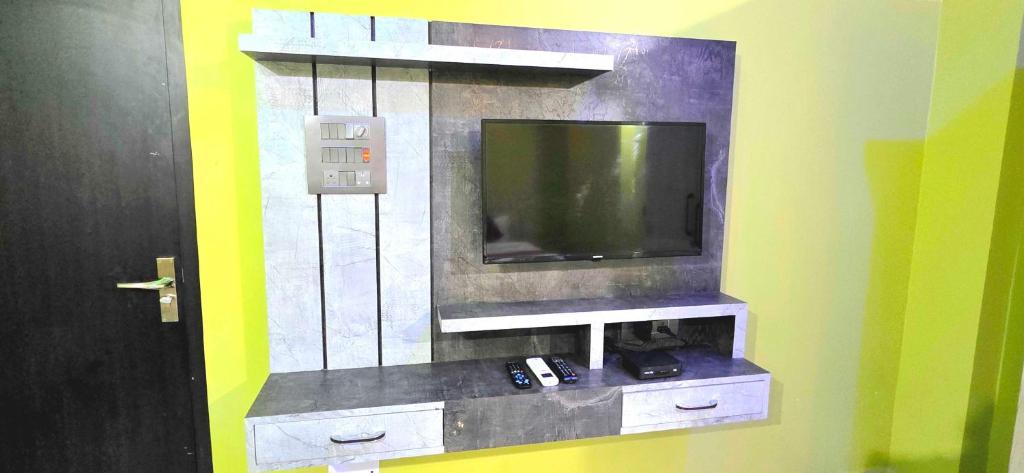 a flat screen tv on a wall in a room at Super Hotel O J.T. Residency in Rānchī