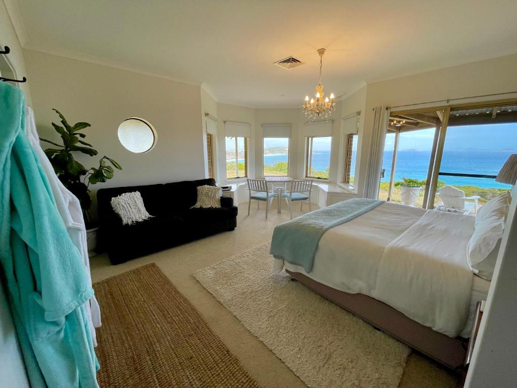 a bedroom with a bed and a view of the ocean at Blue Haven Beach House - Guest Suite I 