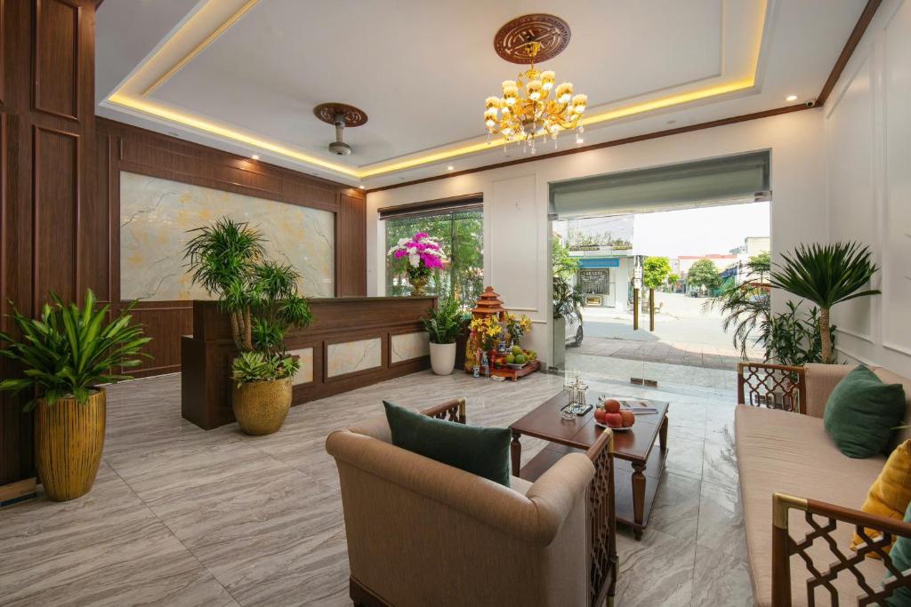 a lobby with chairs and a table and potted plants at Royal Hotel & Spa in Ðồng Ky