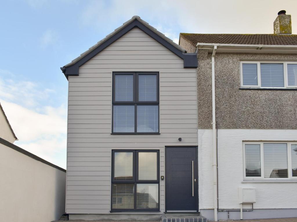 a white house with a black door at Little Trevose in Padstow