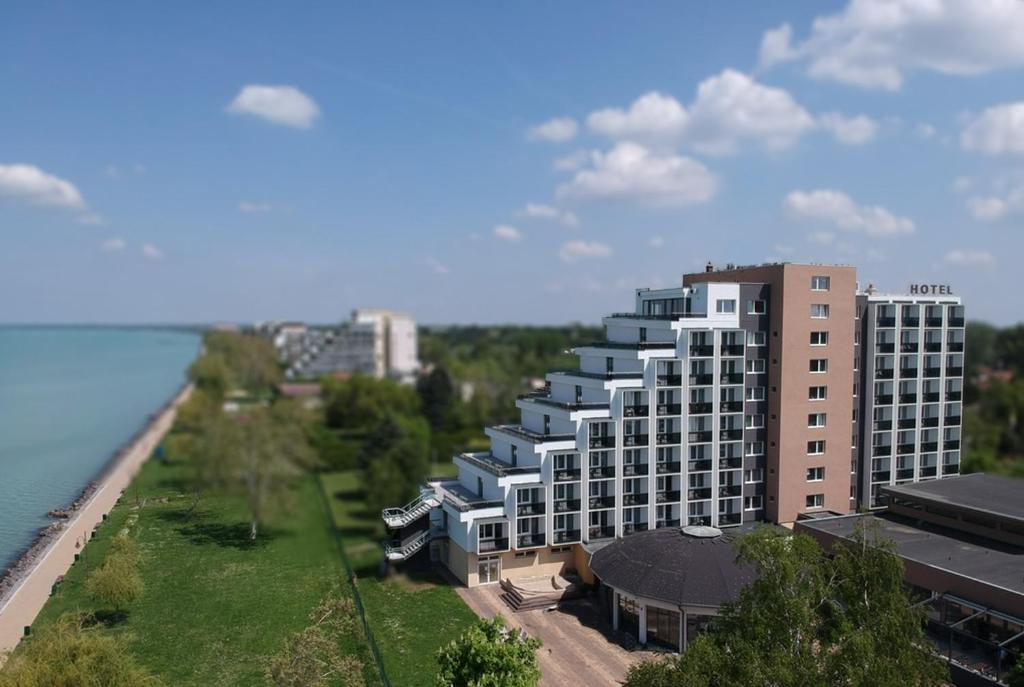 an aerial view of a building next to the water at Premium Hotel Panoráma in Siófok