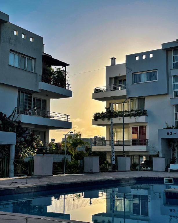 a view of two apartment buildings with a swimming pool at RIX Apartments in Kyrenia