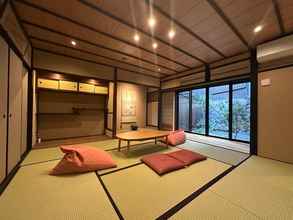 a room with a table and two pillows on the floor at Authentic Kyoto Machiya Sleeps 7 Near Station in Fushimi