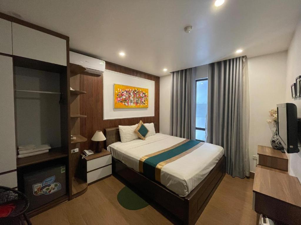 a hotel room with a bed and a television at Hoan Kiem Old Quarter Hotel Alley 22 Hang Voi in Hanoi