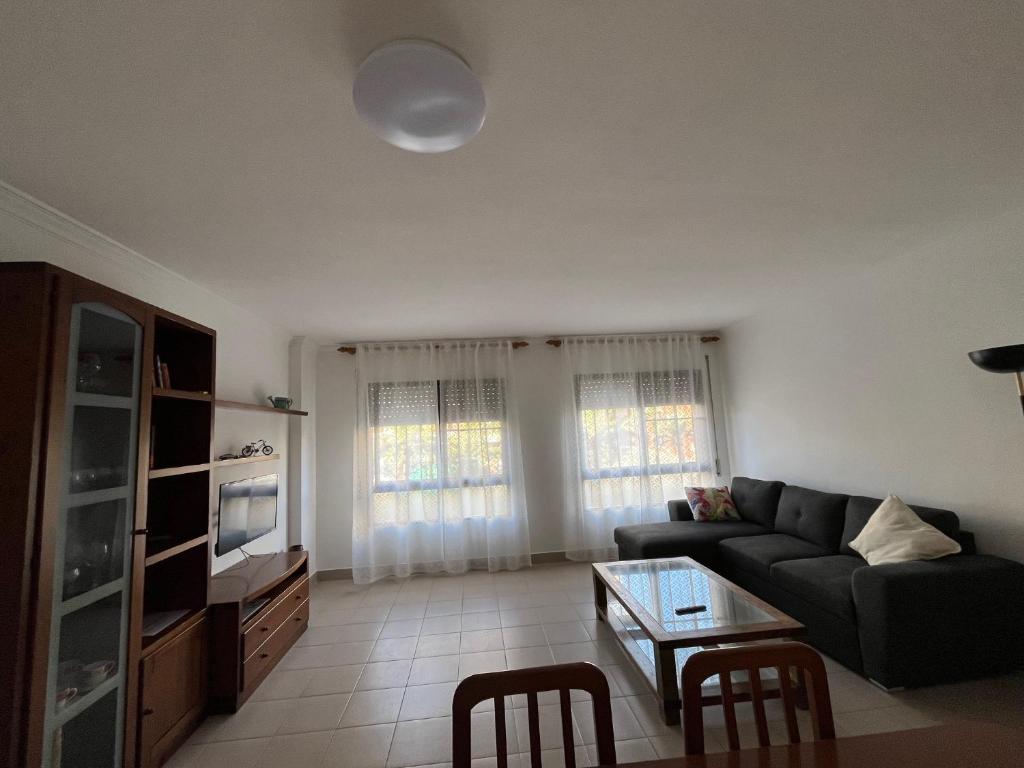 a living room with a couch and a table at Vacaciones en la playa in Sant Carles de la Ràpita