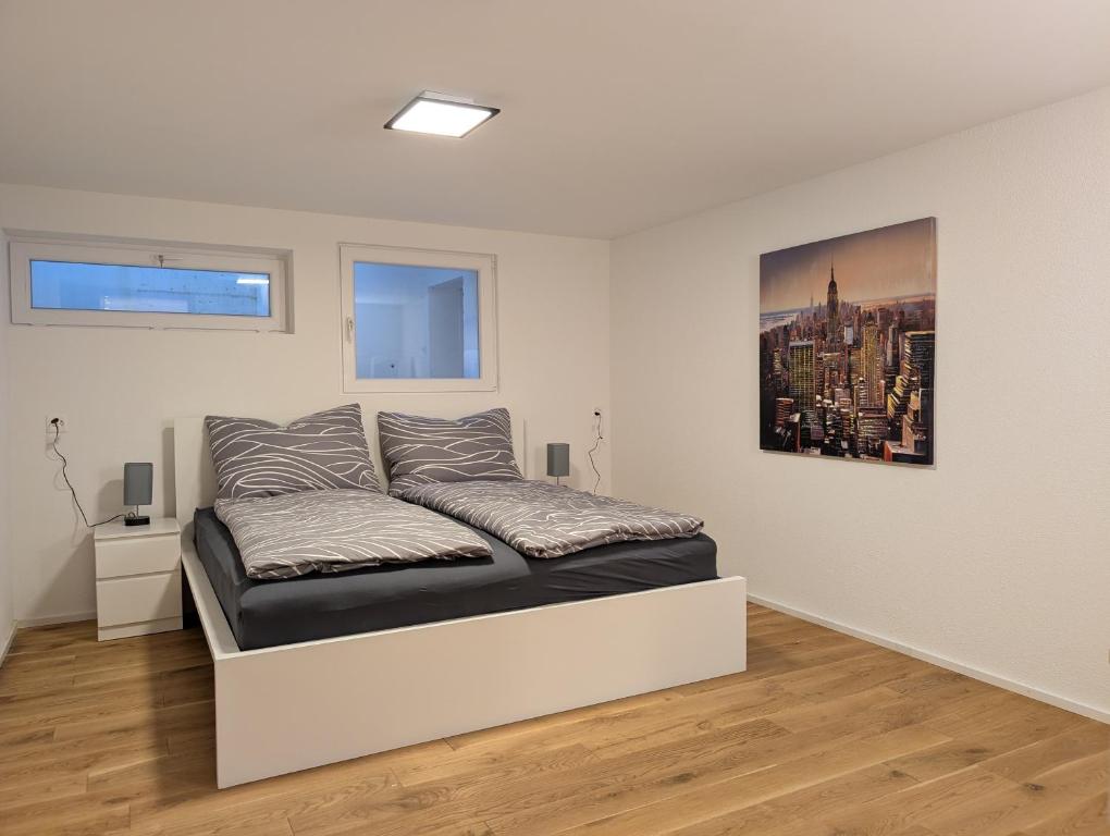 a bedroom with a bed in a white room at Renovierte Wohnung in 8903 Birmensdorf in Birmensdorf