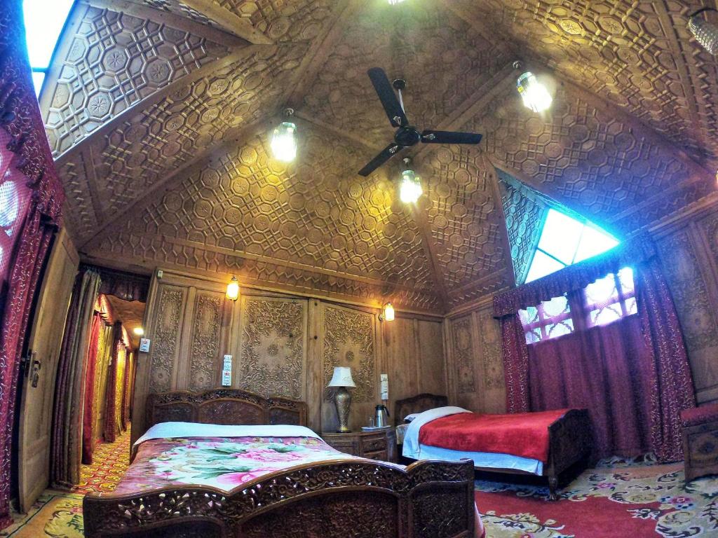 een kamer met 2 bedden en een plafond bij Chicago Group of Houseboats in Srinagar