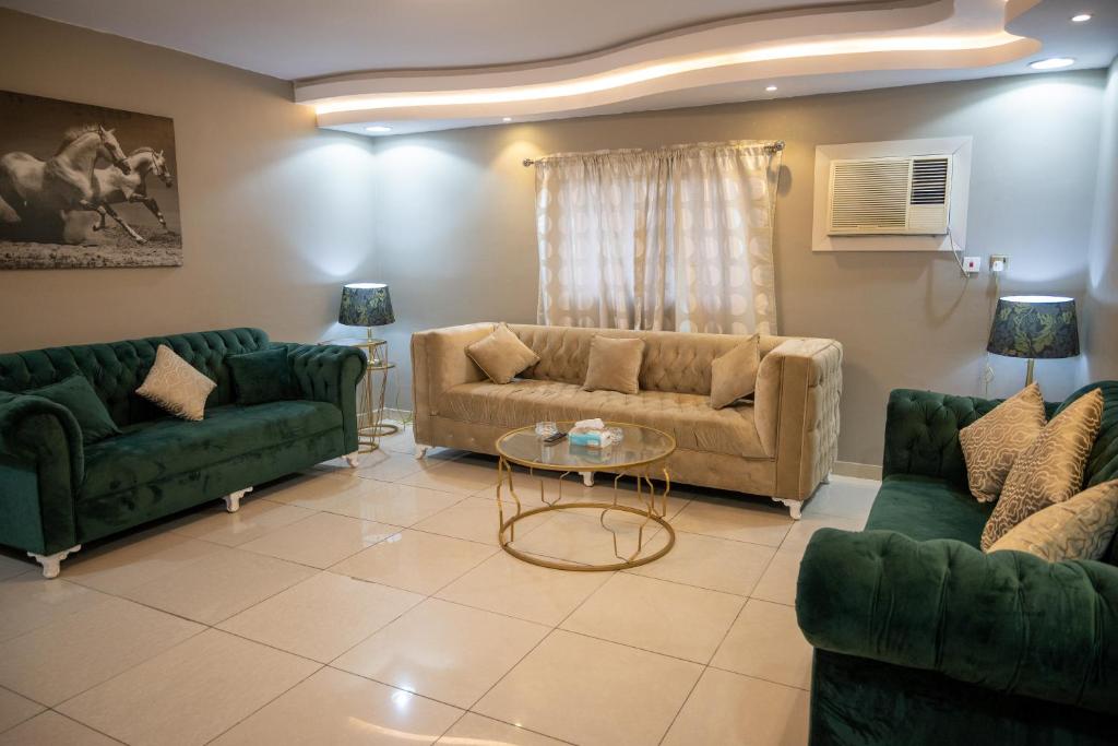 ジッダにあるMira AlSafaのソファ2つとテーブルのあるリビングルーム