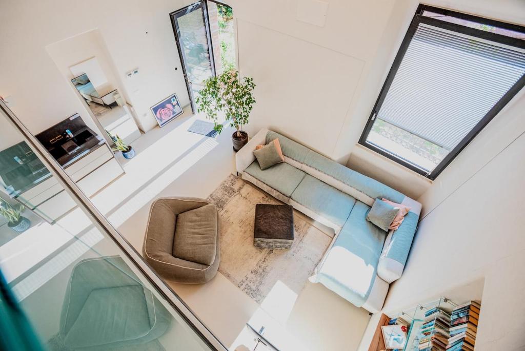 an overhead view of a living room with a couch and chair at Loft In Centro in Forlì