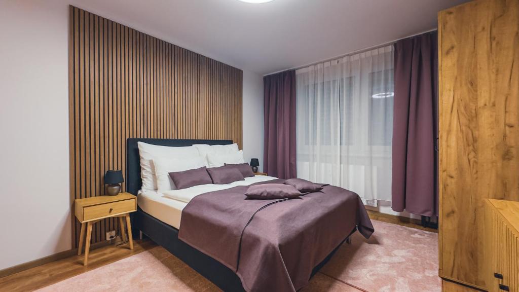 a bedroom with a large bed and a window at Apartmán Astana in Levoča