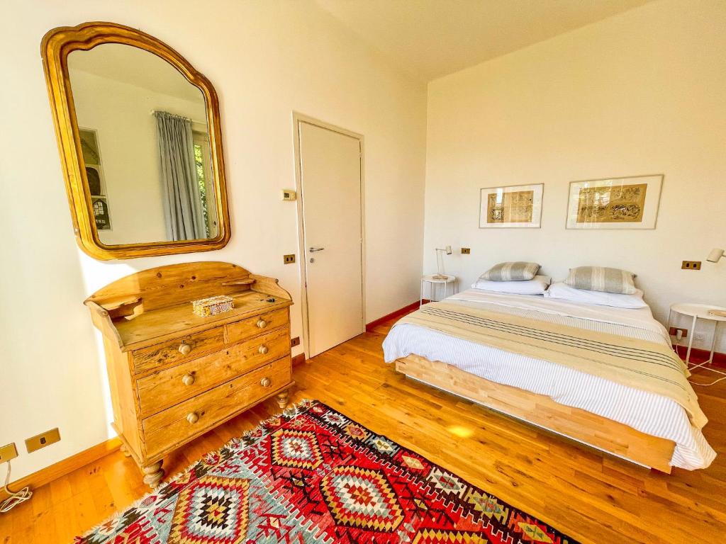 a bedroom with a bed and a large mirror at Casa Tranquilla in Cannobio