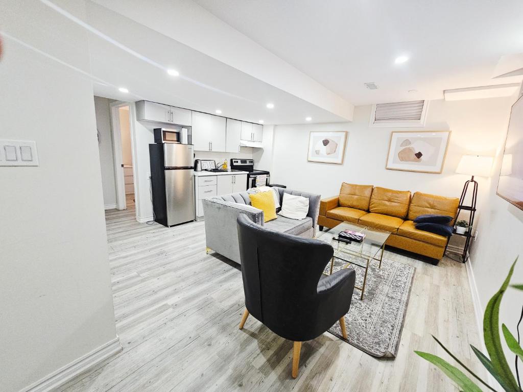 a living room with a couch and a table at Garden Ave Suite 3 Mins to Hwy 403 in Brantford