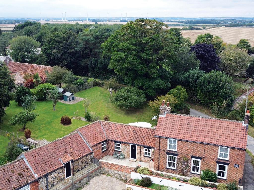 an aerial view of a brick house with a yard at West End Farmhouse in Barmston