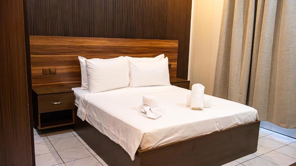 a hotel room with a bed with towels on it at Valhali Guesthouse in Huraa