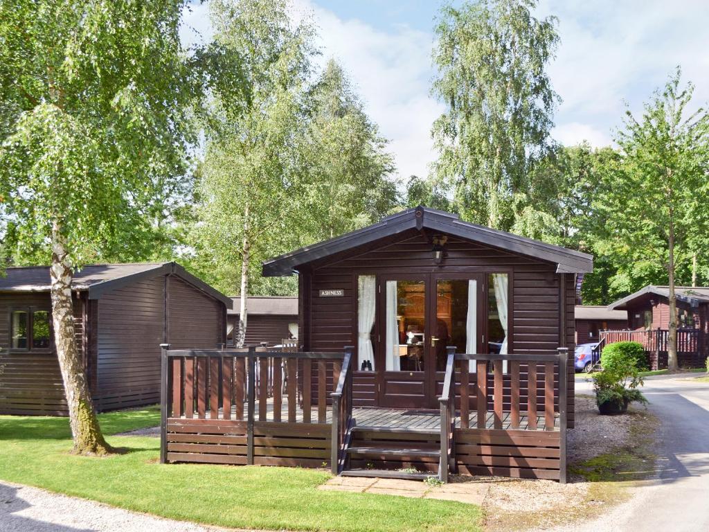 a wooden cabin with a porch in a yard at Ashness in Keswick