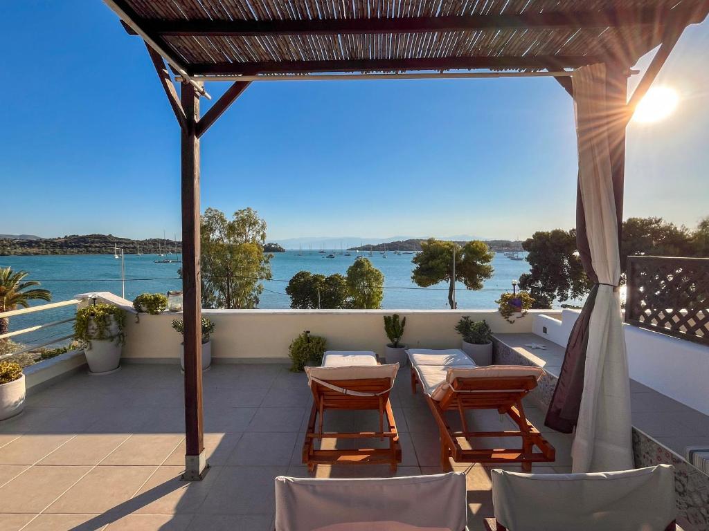 a patio with chairs and a view of the water at Sea Breeze - Home with a View in Bouzéïka