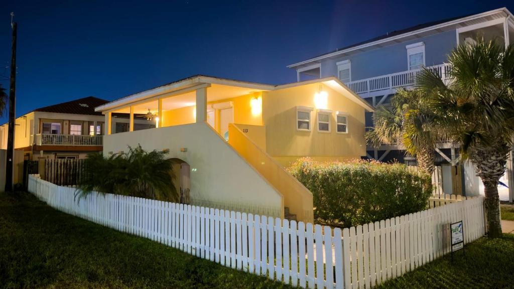 a white fence in front of a house at Four Bedroom Two Level Home Near Beach in South Padre Island