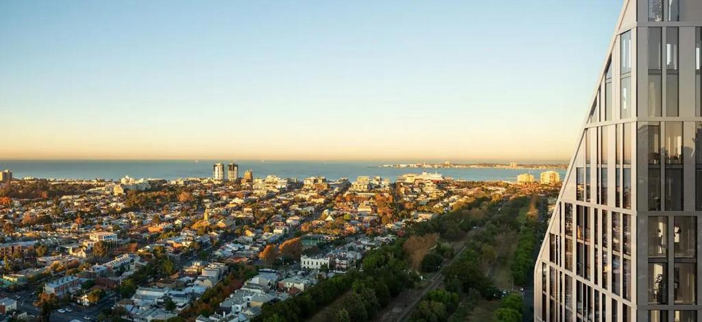 an aerial view of a city with a tall building at Deluxe apartments in the heart of South Melbourne in Melbourne