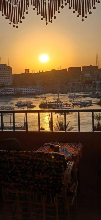 a sunset over a harbor with boats in the water at Masa Nubian House in Aswan