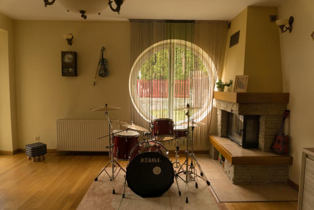 una sala de estar con una batería y una chimenea en Vila Vladimir, en Poiana Brasov