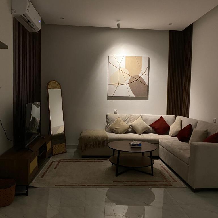 a living room with a couch and a table at روڤان in Hafr Al-Batin