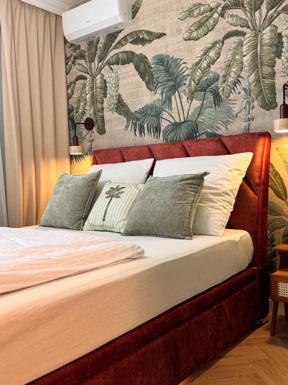 a bed in a bedroom with a wall mural at Terra Rosa in Radom