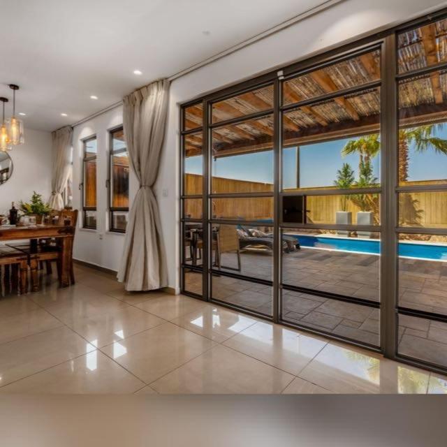 a living room with a large sliding glass door at Perfect Family Vacation-Private Pool Eilat in Eilat