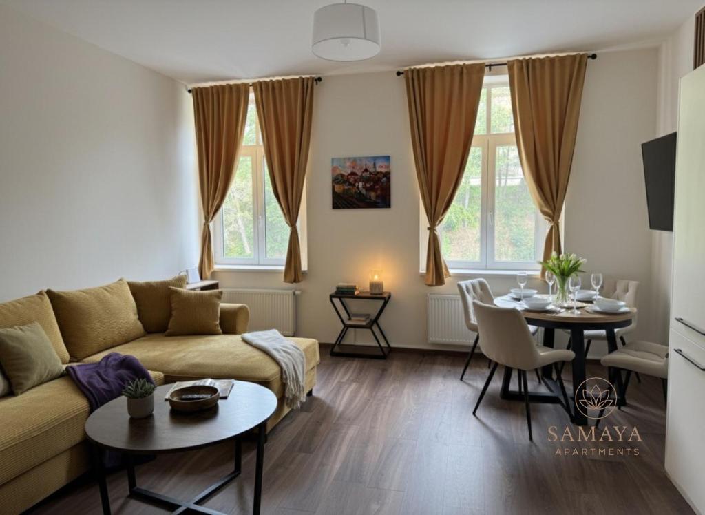 a living room with a couch and a table at Samaya Apartment in Litoměřice